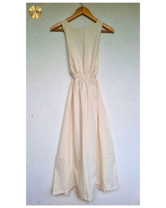 Beige dress on a wooden hanger against a white wall