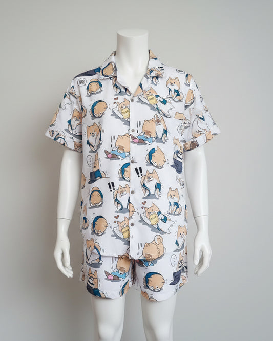 Folded fabric with cartoon character pattern on a wooden hanger against a white wall.