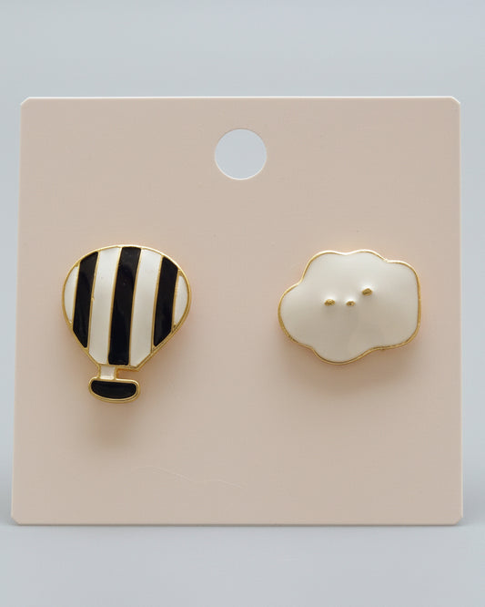 Pair of earrings shaped like a hot air balloon and a cloud on a display card.