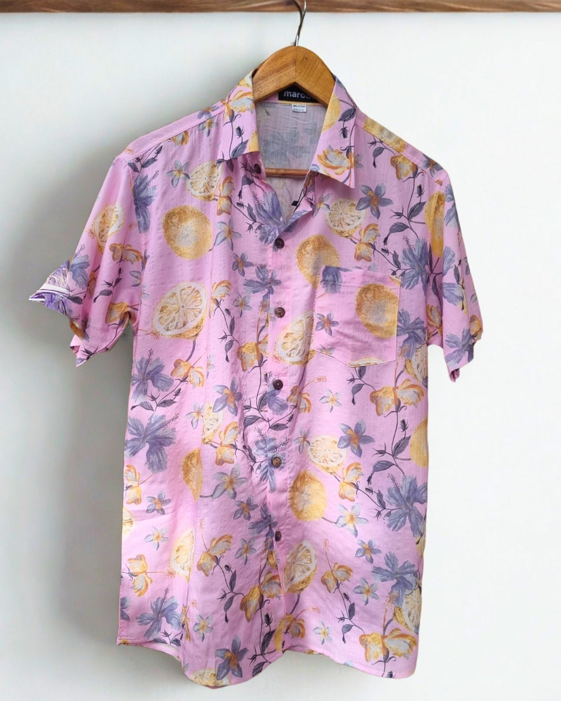 Pink floral shirt on a hanger against a white background with CHI logo.
