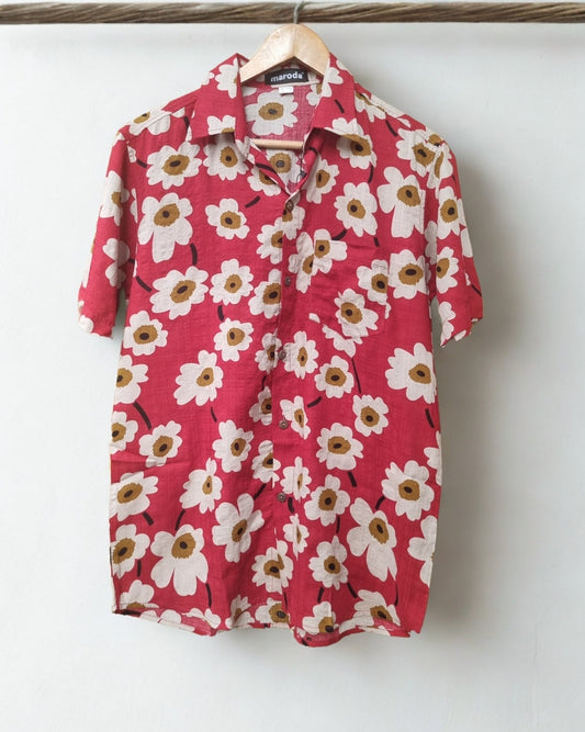 Pink floral shirt on a hanger against a white background