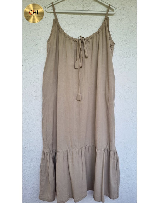 Beige dress on a hanger against a white background