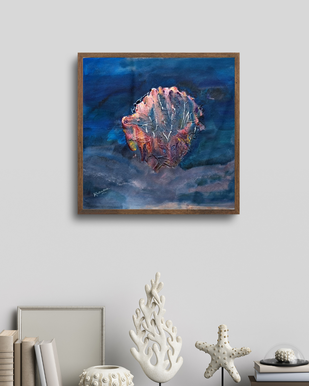 Framed abstract painting on a wall with decorative items below