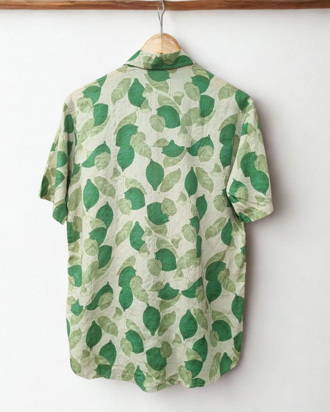 Green leaf-patterned shirt on a hanger against a white background with 'CHI' logo.