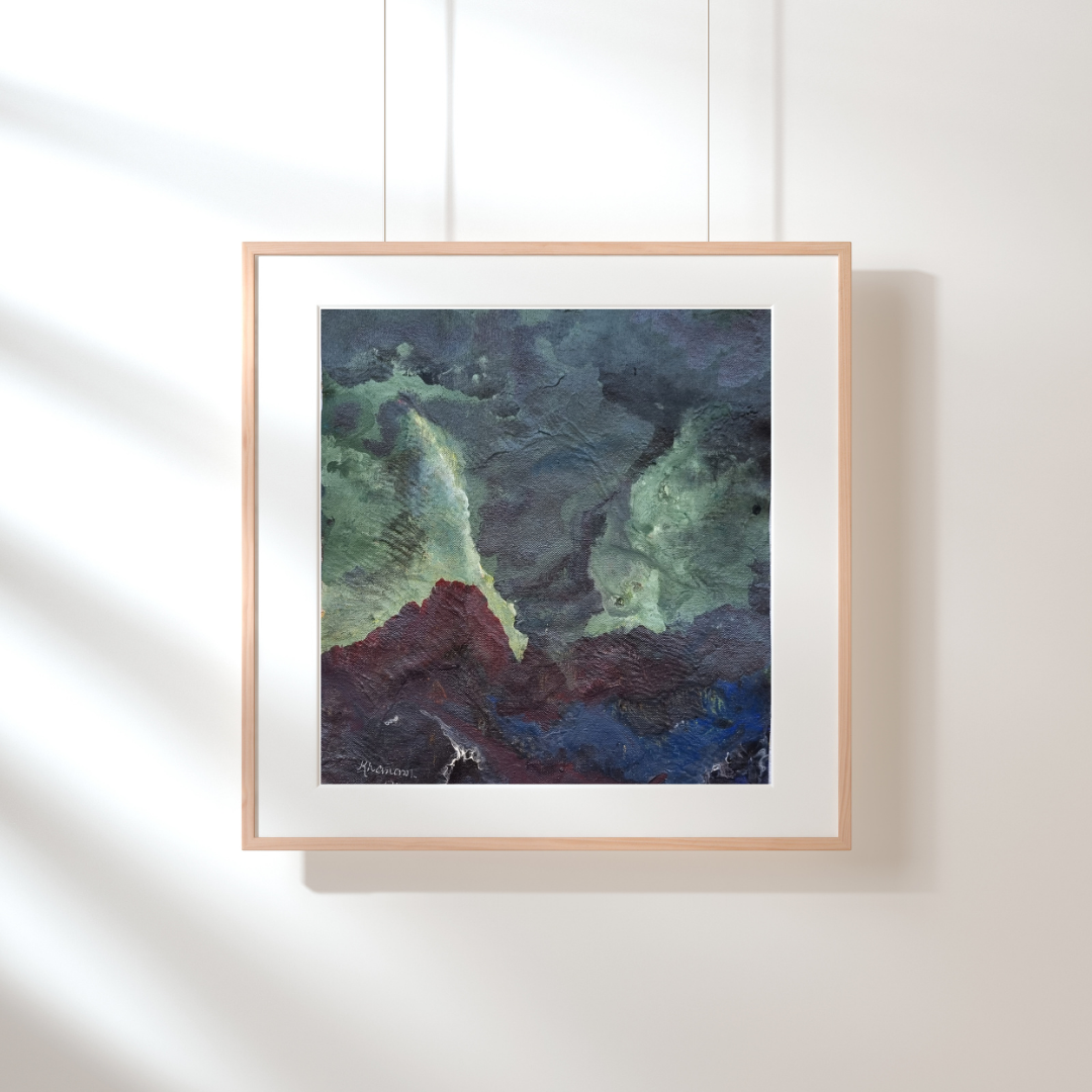 Framed abstract artwork with green, blue, and brown tones on a white wall.