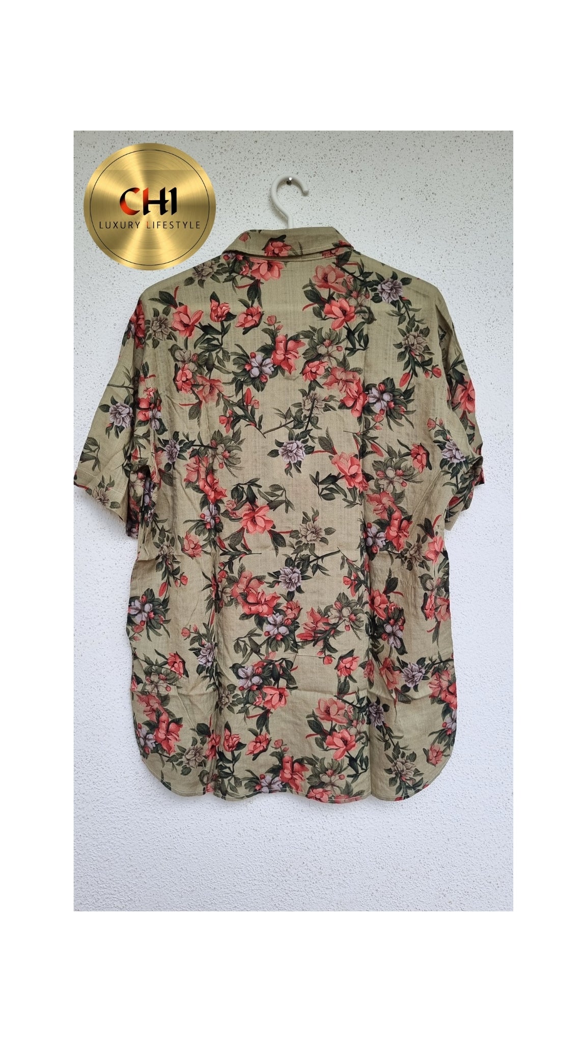Floral patterned shirt on a hanger with a visible brand logo.