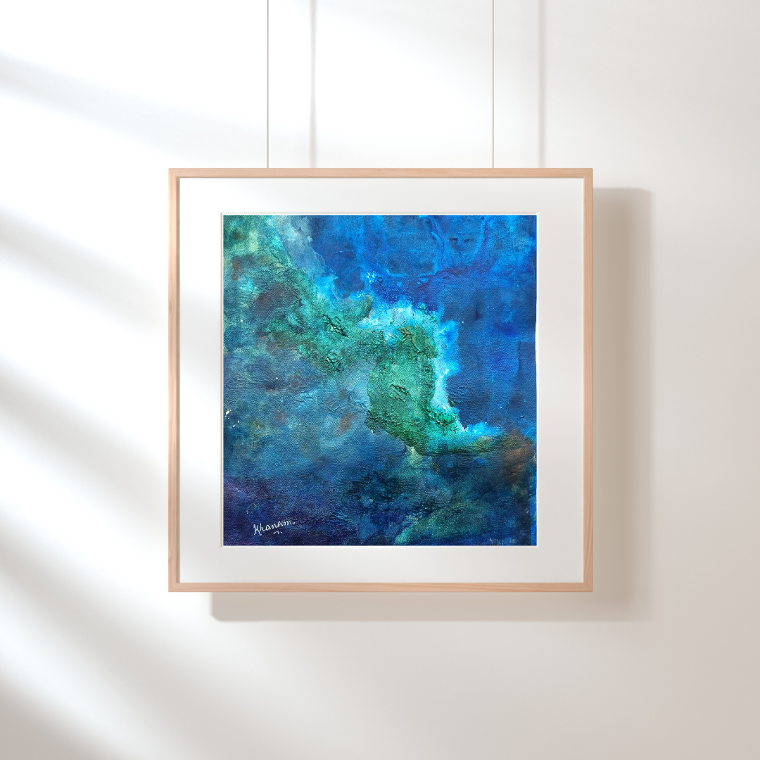 Framed abstract art print with blue and green hues on a white wall