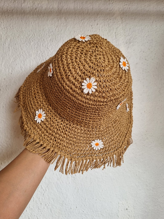 Brown woven bag with white flowers on a light background