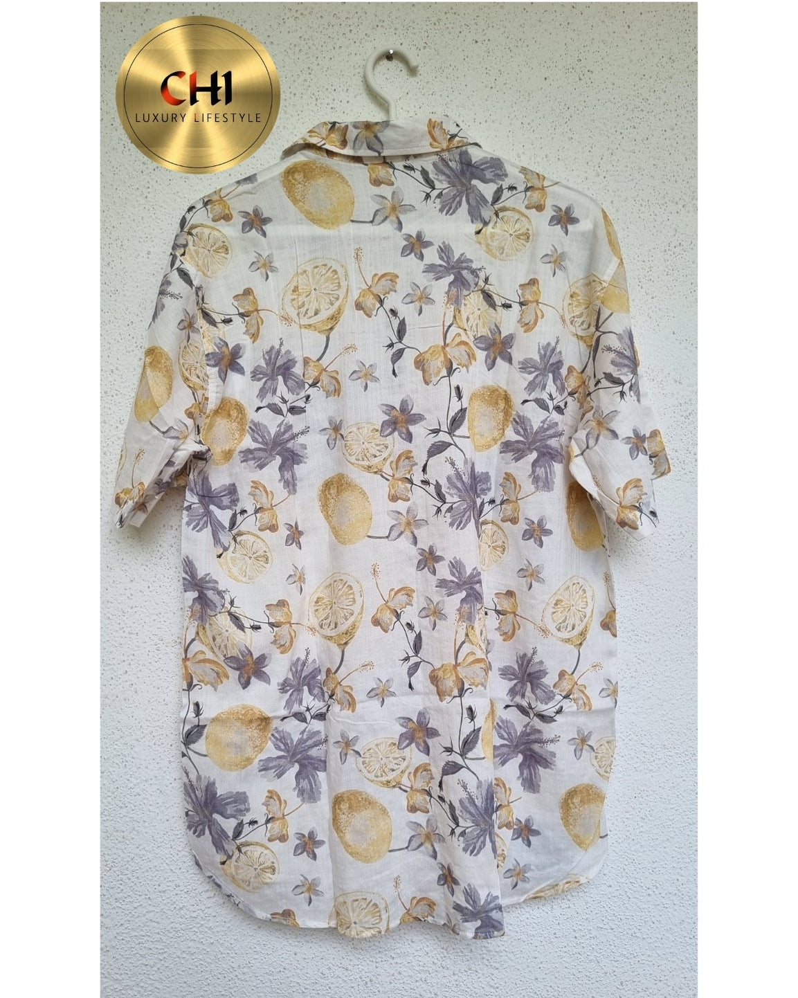 Floral-patterned shirt on a hanger with 'CHI' brand logo.