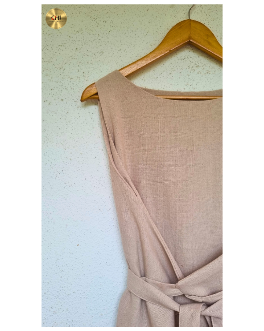 Beige dress on a wooden hanger against a light background